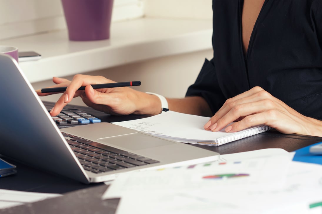 Close-up of Female Accountant Making Calculations